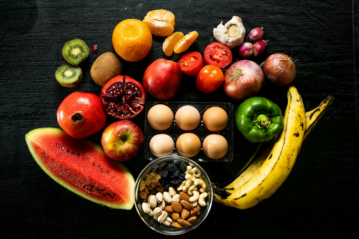 Healthy eating spread with fresh vegetables, fruits and grains